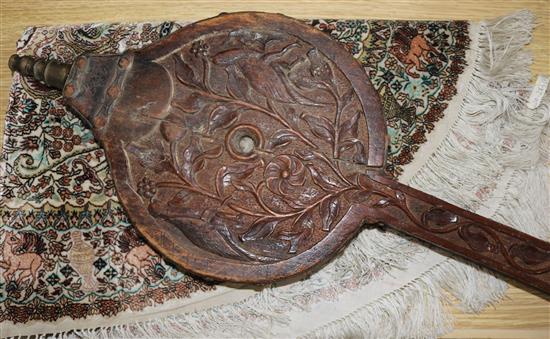 A pair of Victorian bellows, intricately carved with dogs and a leopard amongst foliage, 2ft 11in.